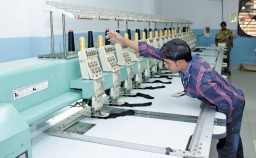 Logos being embroidered on socks