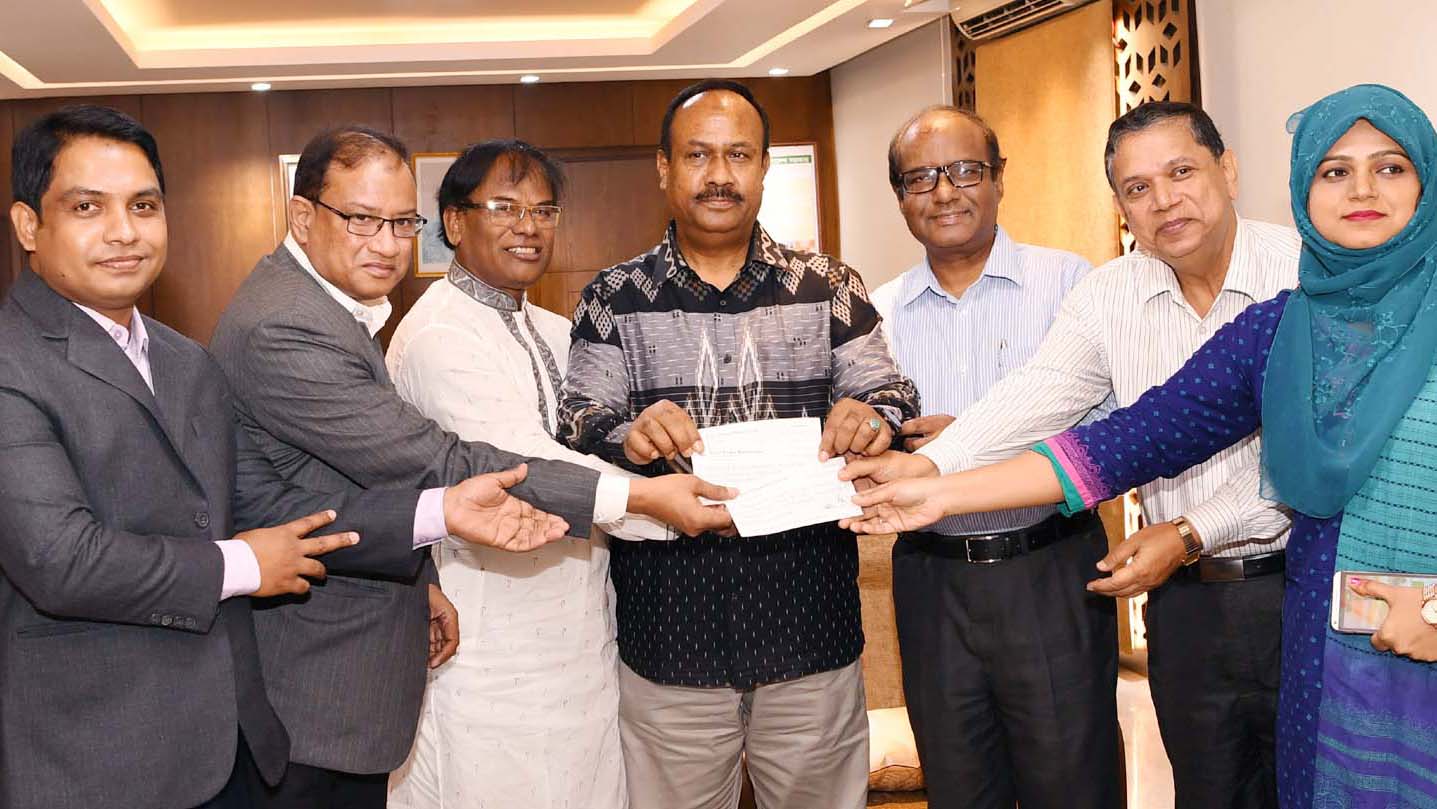 State Minister for Labour and Employment Md. Mujibul Haque (centre) accepting the cheque of contribution from BSRM.